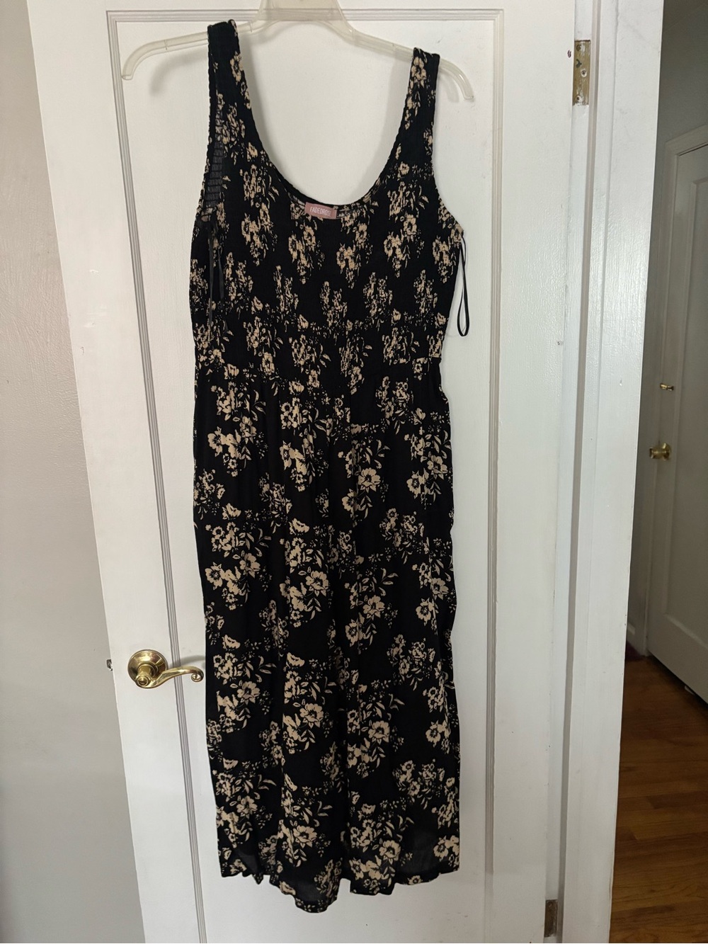 Black Floral romper with Cream Floral Print. Mid calf length, flowy, pockets